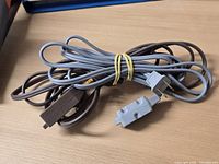 Bundle of brown and gray cords showing plugs and receptacle ends