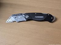 Knife folded out showing overall design, handle texture, blade guard