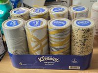 Front view of eight sealed Kleenex cylinders in retail tray