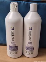 Front view of both Biolage Ultra Hydra Source liter bottles showing labels and seals