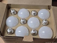 Open box showing eight LED bulbs seated in cardboard