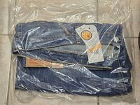 Folded Levi's jeans sealed in plastic with tags visible