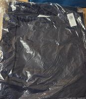 Front view of sealed jeans with tag visible