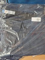 Full view of sealed jeans in poly bag