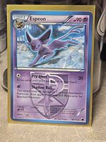 Front of Espeon Plasma Freeze card in sleeve