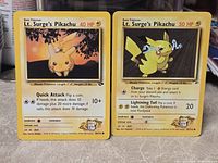 Fronts of both Lt. Surge's Pikachu cards showing artwork, HP, attacks and set numbers