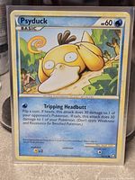 Front view of sleeved Psyduck card in toploader