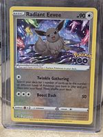 Front of card in sleeve showing holographic Radiant Eevee details and SWSH230 promo stamp