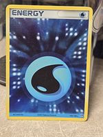 Front of Water Energy holo card showing foil pattern and 105/108 numbering