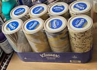 Front view showing 8 sealed Kleenex cylinders in blue retail tray