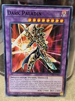 Front of Dark Paladin card showing title, artwork, stats, edition and set code