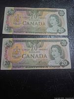 Front view of both $20 Bank of Canada notes