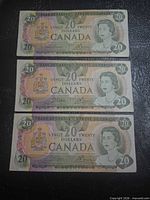 Front view of three Canadian $20 notes stacked