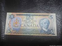 Obverse of 1979 Canada $5 note showing portrait, denomination, coat of arms, signatures
