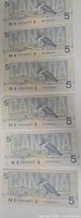 Reverse of six notes featuring belted kingfisher