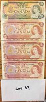 All four banknotes stacked for overview