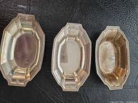 Three Gorham sterling silver open salt cellars shown top view