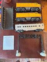 Two yellow Union Pacific 2023 locomotives, Maplewood passenger coach, black bridge deck, girder bridge