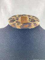 Front view of yellow gold signet ring showing rectangular monogrammed face and filigree shoulders