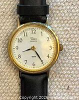 Front view of Timex watch showing dial, bezel, leather strap
