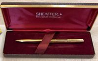 Pen inside open red-lined Sheaffer box