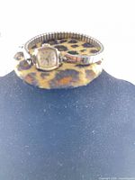 Front view of watch on display stand
