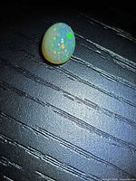 Top view of oval Ethiopian opal showing pinfire play of color