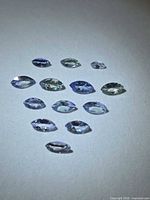 Cluster of marquise tanzanite stones on white background