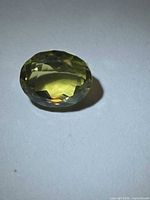 Oblique top view of oval lemon citrine showing color and facets