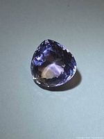 Front view of faceted pear-cut ametrine showing colour zoning