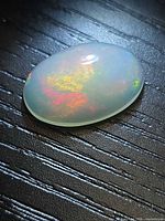 Top view of oval opal showing multicolor flash