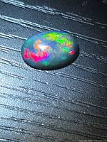 Top view of loose Ethiopian black opal showing multicolour play