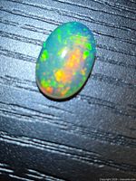 Front view of oval Ethiopian opal showing multicolour play-of-color