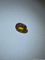 Loose oval golden yellow sapphire front view