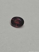 Top view of oval faceted zircon showing color and cut
