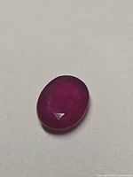 Top view of single oval-cut ruby showing colour and facet pattern