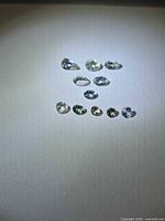 group of 11 faceted tanzanite stones on white background