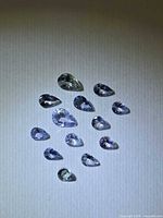 All pear-cut tanzanites grouped on neutral background