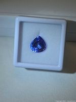 Front view of pear-cut tanzanite in display box