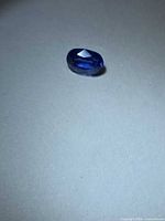 Top view of loose oval blue sapphire