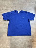 Full front view of royal blue Adidas T-shirt displayed flat