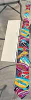 Full view of multicolored Harley-Davidson silk necktie