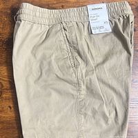 Front view of khaki pull-on shorts with tags attached