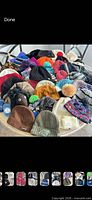Pile view showing majority of knit beanies in assorted colours and styles