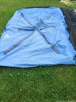 Blue Ozark Trail screen house fabric laid out on grass