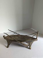 Full view of silver-plated boat dish showing legs, oars, deck