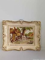 Full view of plaque showing ornate border and central scene