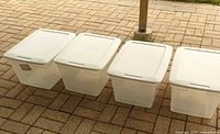 Four Sterilite bins with lids closed, exterior view