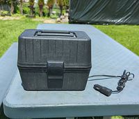 Closed lunch box with power cord visible