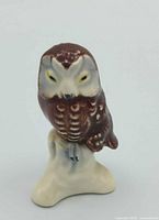 Front view of Goebel porcelain owl figurine showing face, feather detailing, and stump base
